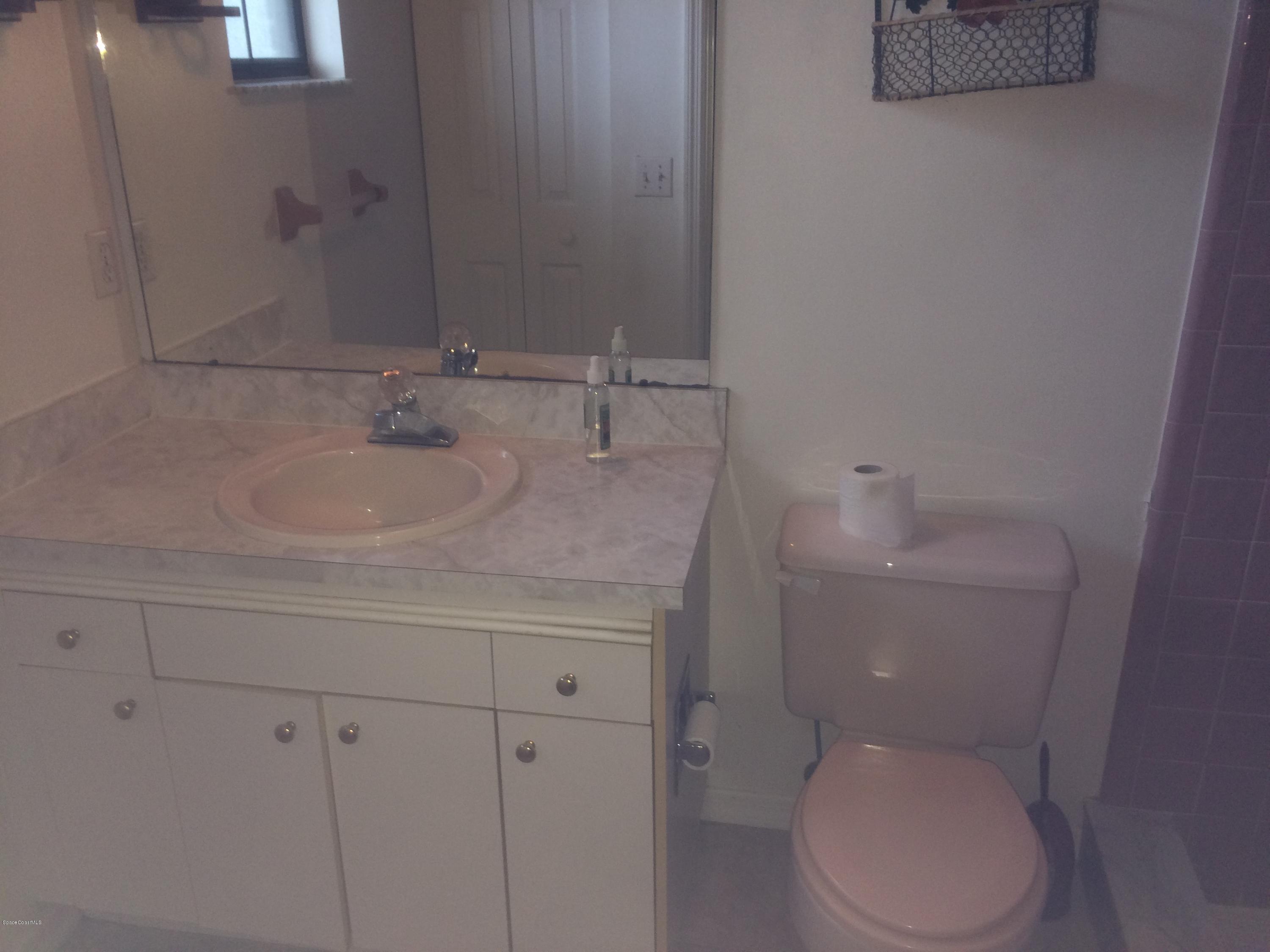 4671 Alfred Street Cocoa, FL 32927 - Photo 9 of 19 a bathroom with a granite countertop toilet and sink