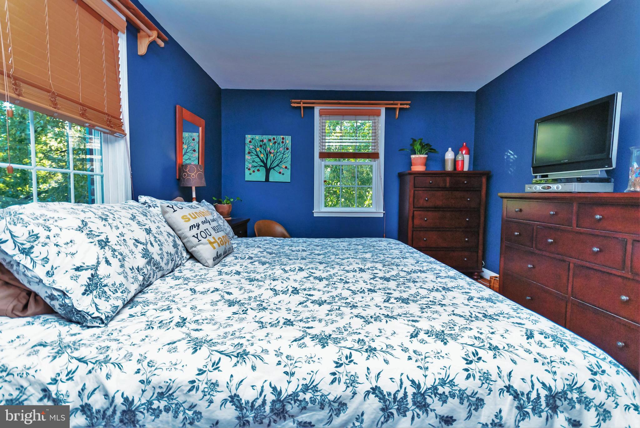 7045 Heathfield Road Baltimore, MD 21212 - Photo 15 of 27 a bedroom with a bed and a flat screen tv