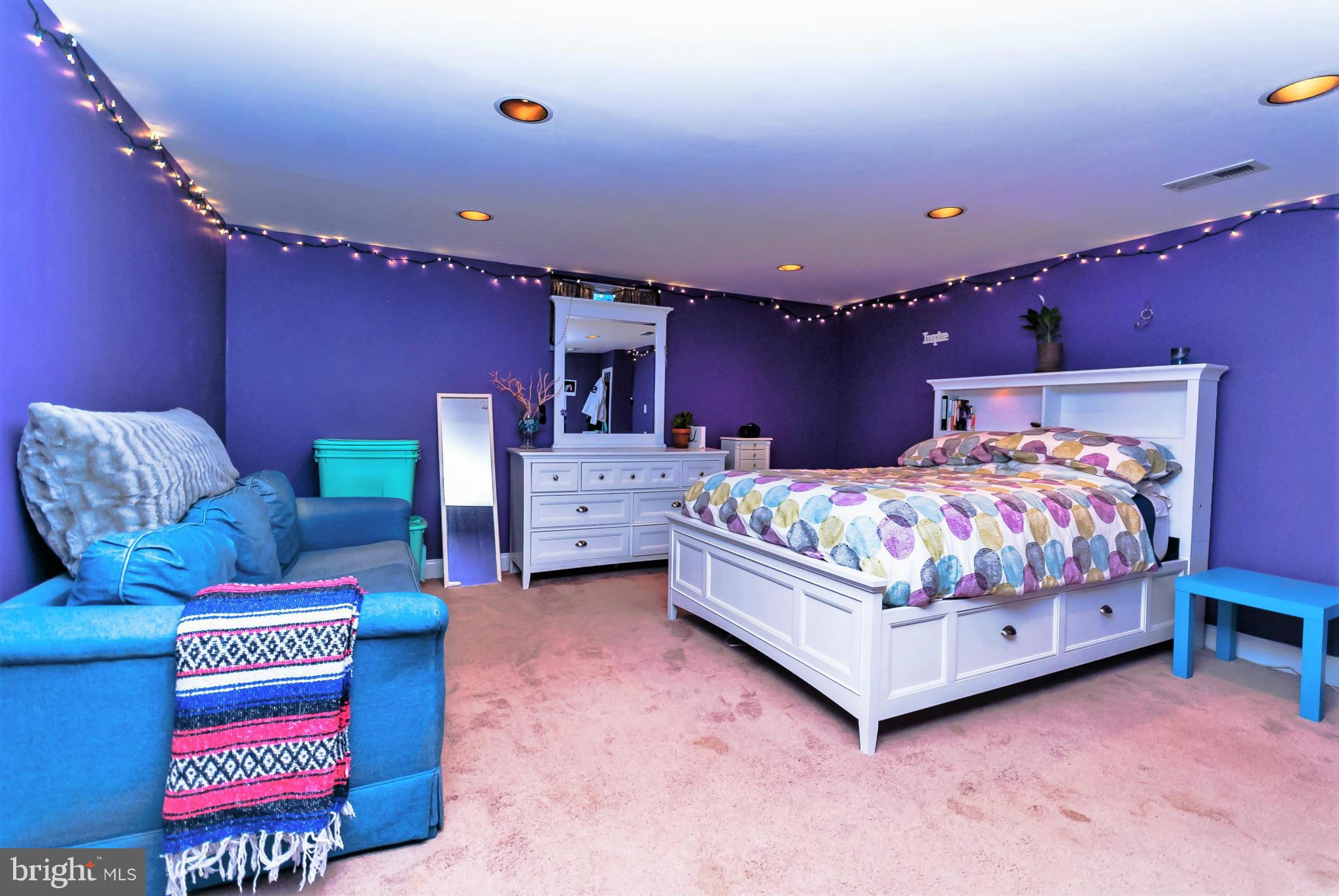 7045 Heathfield Road Baltimore, MD 21212 - Photo 20 of 27 a bedroom with bed and a couch