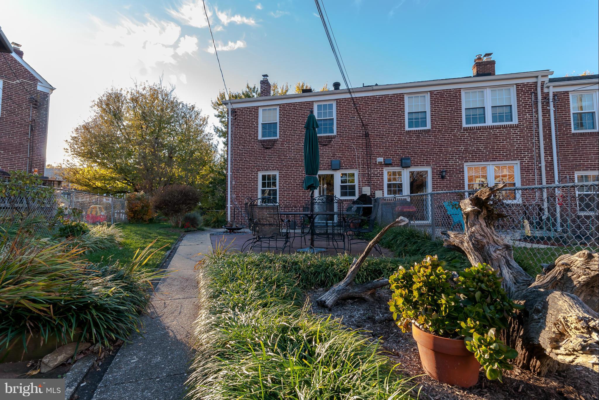 7045 Heathfield Road Baltimore, MD 21212 - Photo 24 of 27 a view of a brick house with a yard and plants