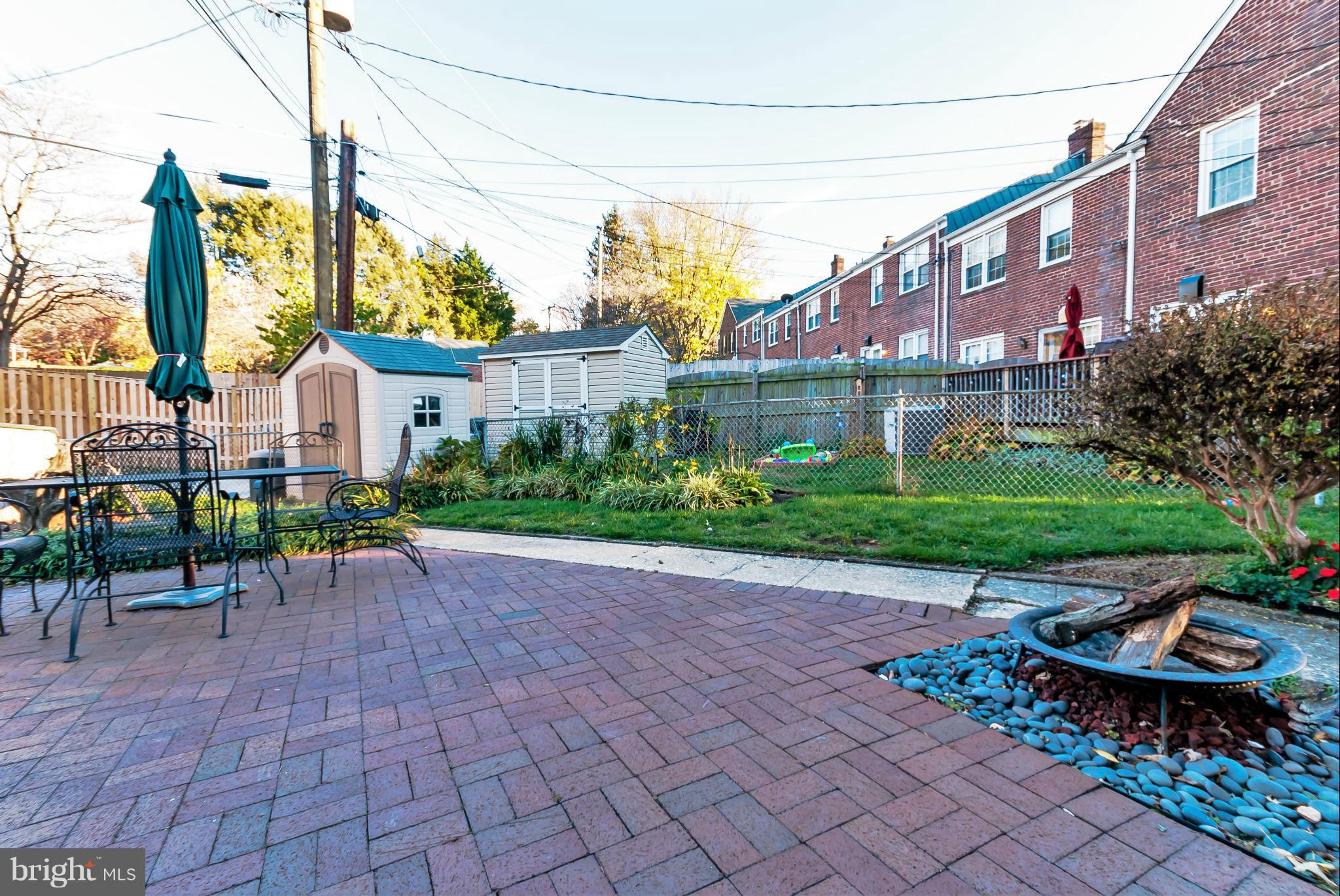 7045 Heathfield Road Baltimore, MD 21212 - Photo 25 of 27 a view of a chair and table in backyard of the house