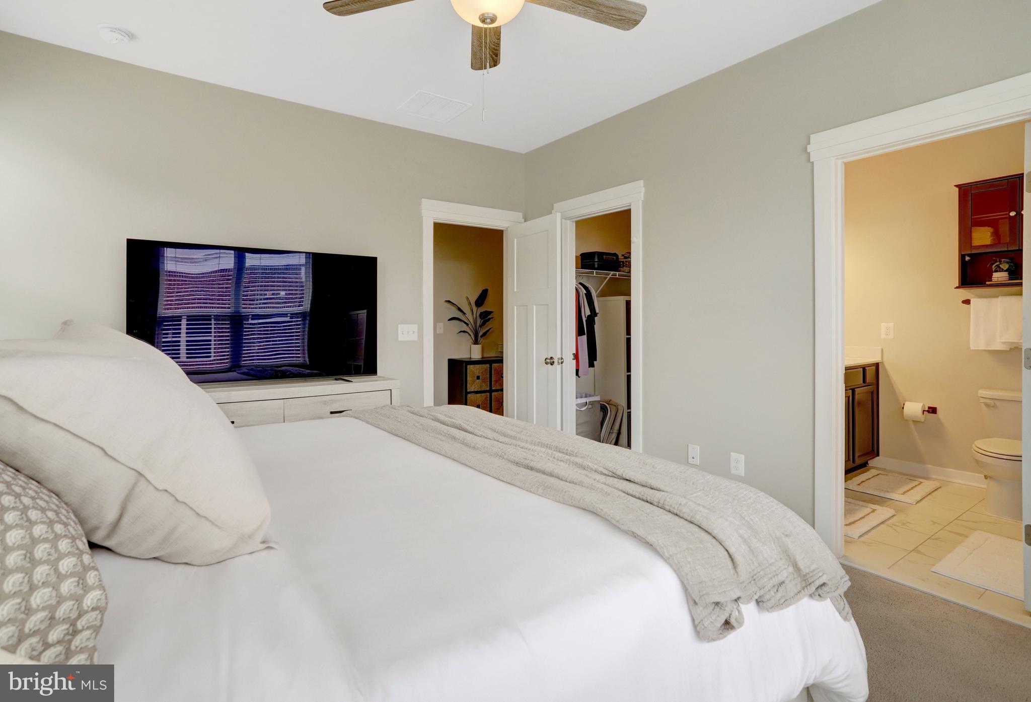 9180 Snowden Ashford Road Lorton, VA 22079 - Photo 21 of 28 a bedroom with a large bed and a chandelier