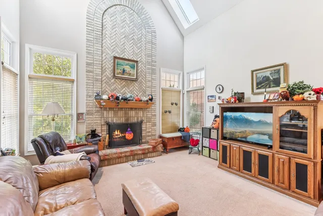 a living room with fireplace furniture and a flat screen tv