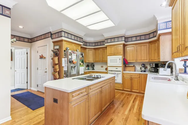 a kitchen with a stove a sink dishwasher and a refrigerator