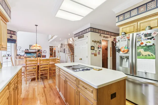 a kitchen that has a table chairs in it and wooden floor