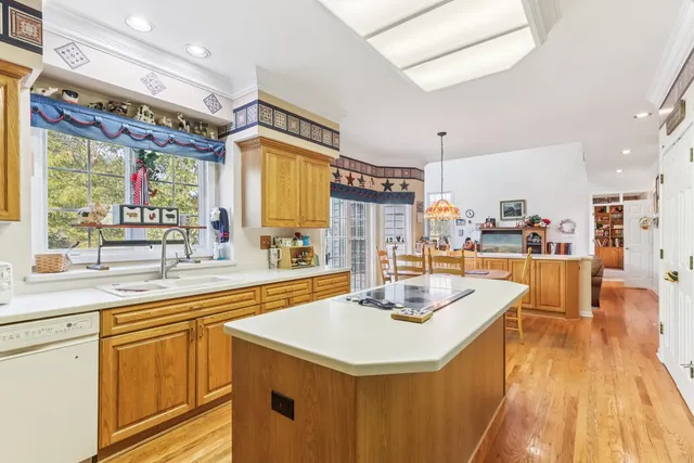 a kitchen with stainless steel appliances granite countertop a sink and a refrigerator