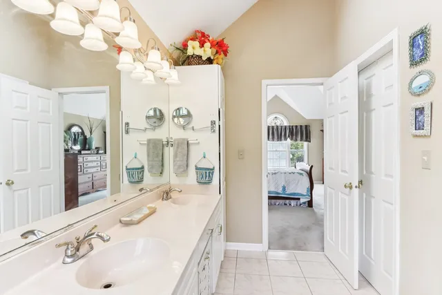 a spacious bathroom with a sink double vanity and a mirror