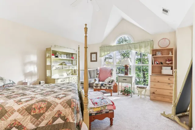 a bedroom with furniture and a large window