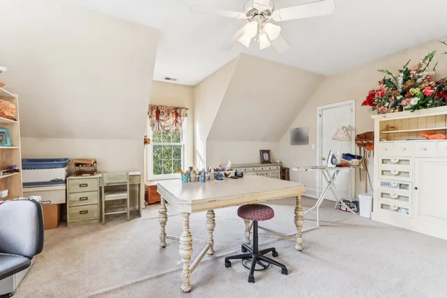 a view of a workspace with furniture and a kitchen
