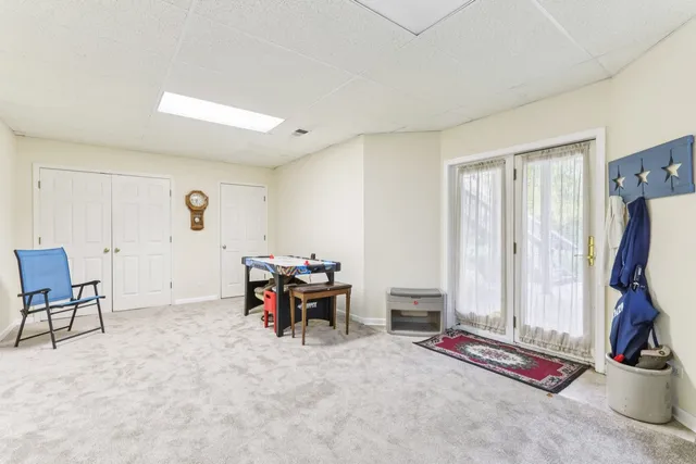 a room with furniture pool table and windows