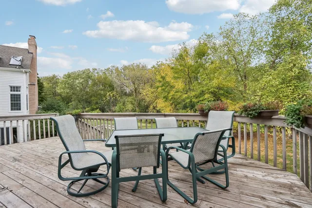 a view of a house with a yard and potted plants