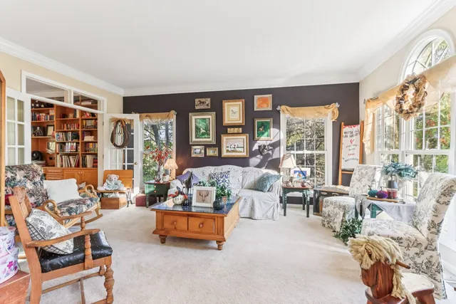 a living room with furniture and floor to ceiling windows