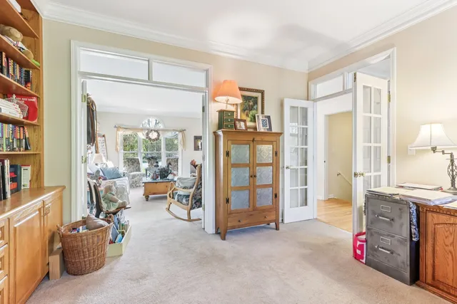a living room with furniture and a floor to ceiling window