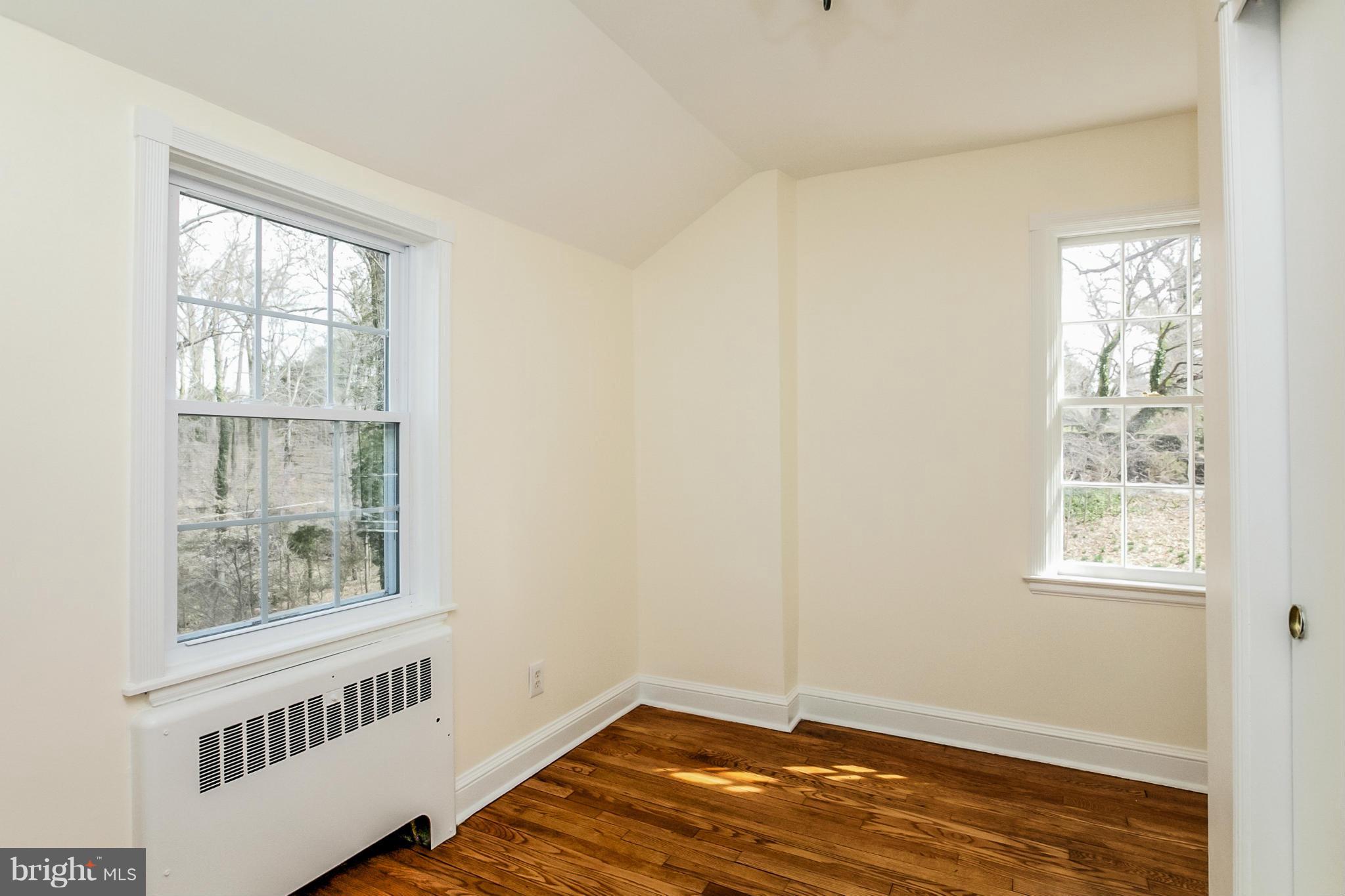 1006 Bellemore Road Baltimore, MD 21210 - Photo 22 of 30 a view of an empty room with wooden floor and a window