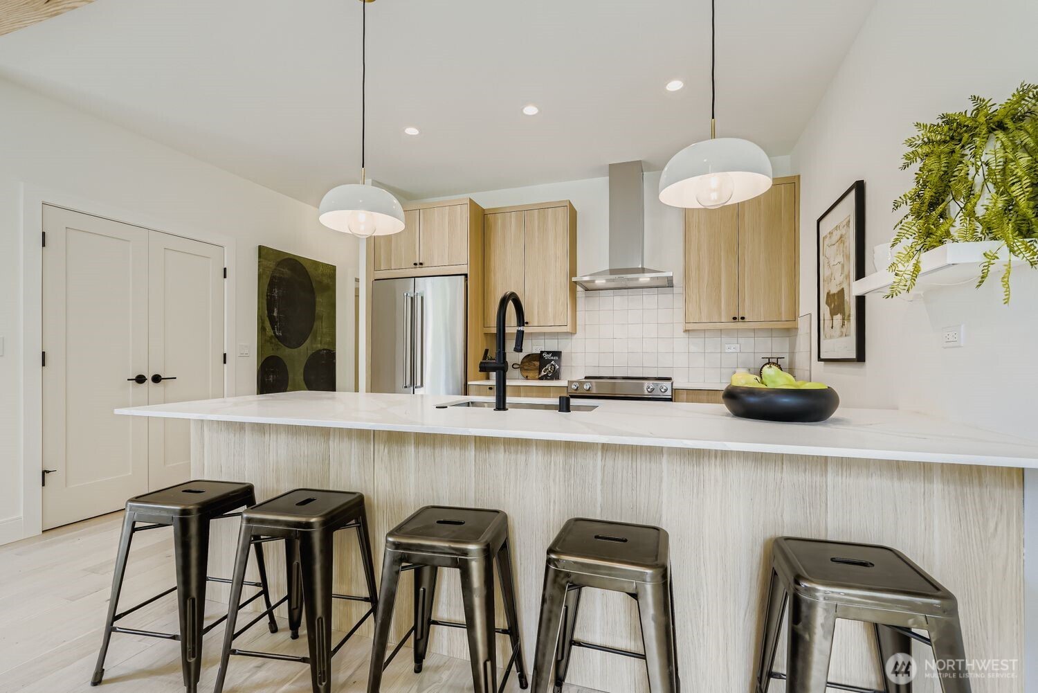 8814 41st Avenue Southwest Seattle, WA 98136 - Photo 11 of 38 a kitchen with stainless steel appliances a table chairs in it and wooden floors