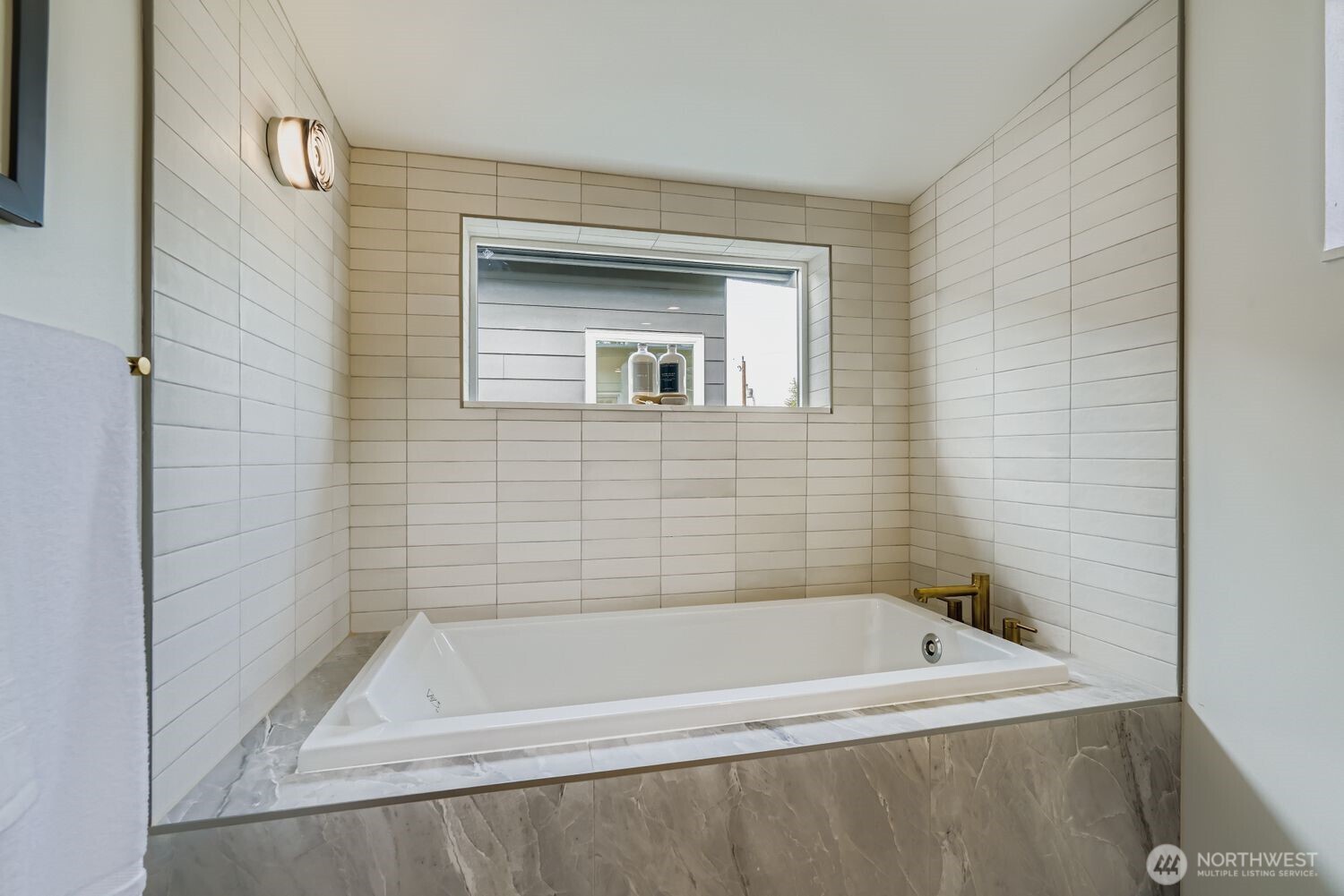 8814 41st Avenue Southwest Seattle, WA 98136 - Photo 19 of 38 a bath tub sitting next to a white sink