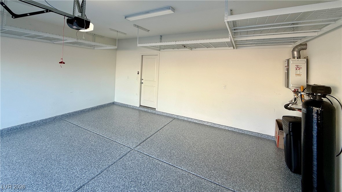 3119 Magnolia Rnch Avenue Las Vegas, NV 89139 - Photo 14 of 17 Garage with a garage door opener and tankless water heater