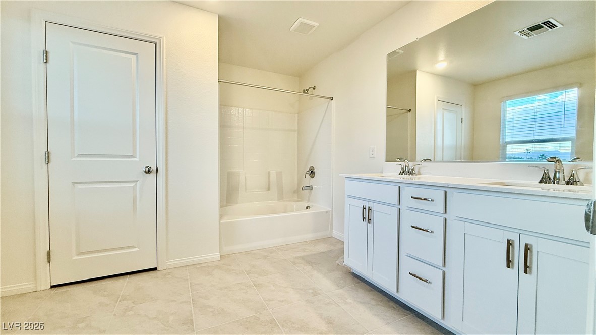 3119 Magnolia Rnch Avenue Las Vegas, NV 89139 - Photo 7 of 17 Full bath with shower / washtub combination, double vanity, and light tile patterned floors