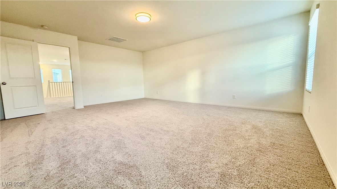 3119 Magnolia Rnch Avenue Las Vegas, NV 89139 - Photo 9 of 17 Unfurnished room with light carpet and baseboards