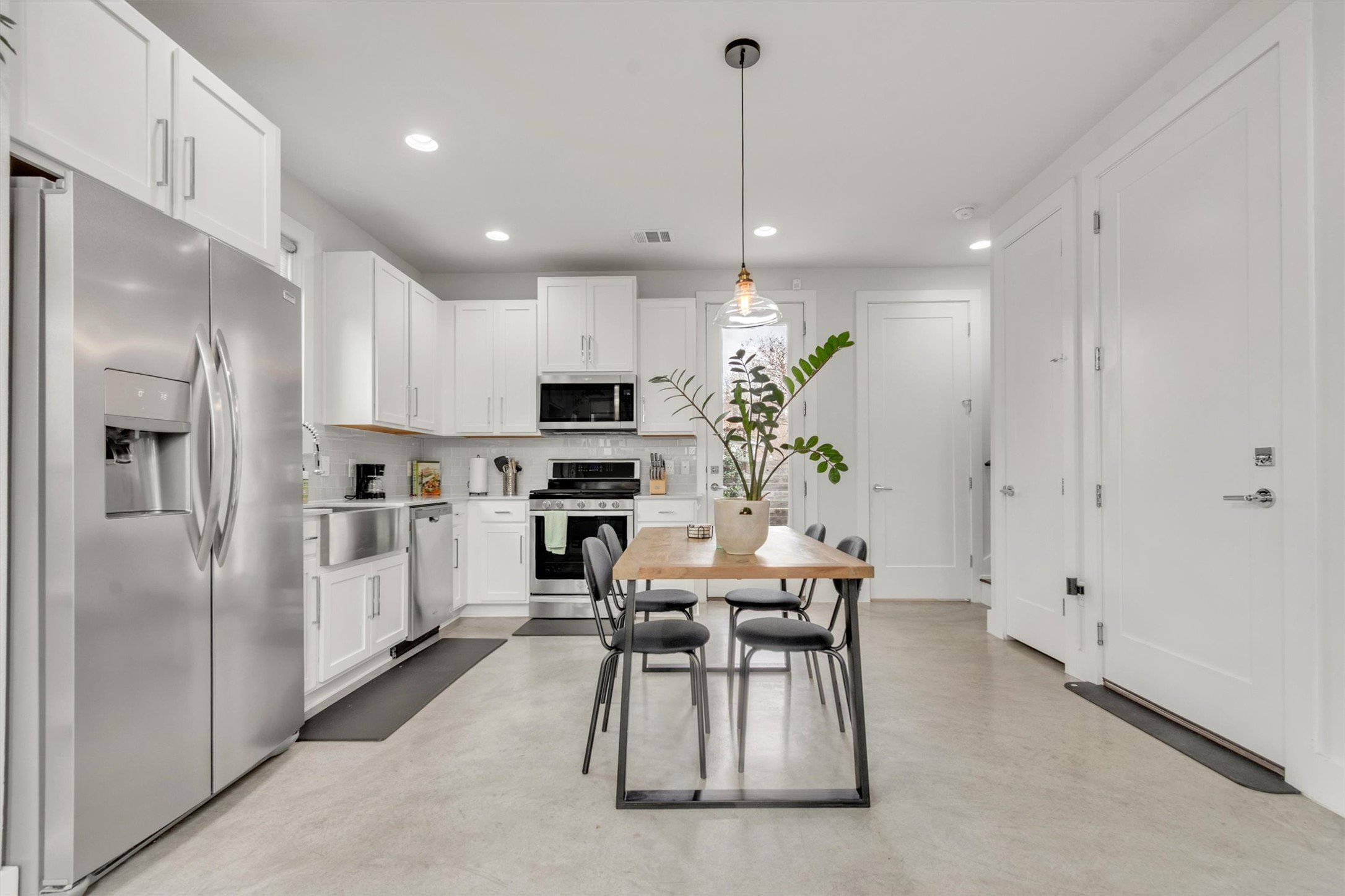 2706 Zaragosa Street, Unit 2 Austin, TX 78702 - Photo 3 of 25 Sleek white cabinetry, quartz countertops, and stainless appliances — a kitchen you'll love cooking in.
