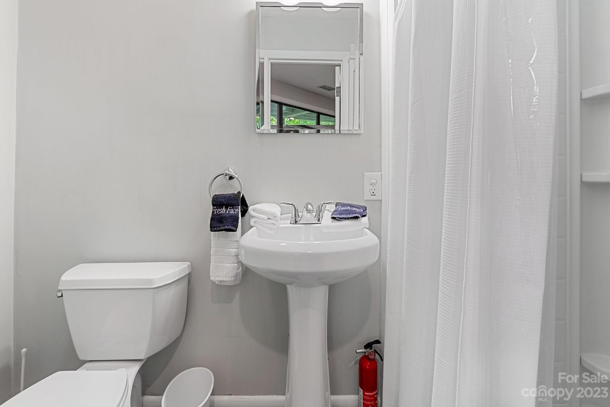 98 Westminster Road Montreat, NC 28711 - Photo 30 of 37 a bathroom with a toilet sink and mirror