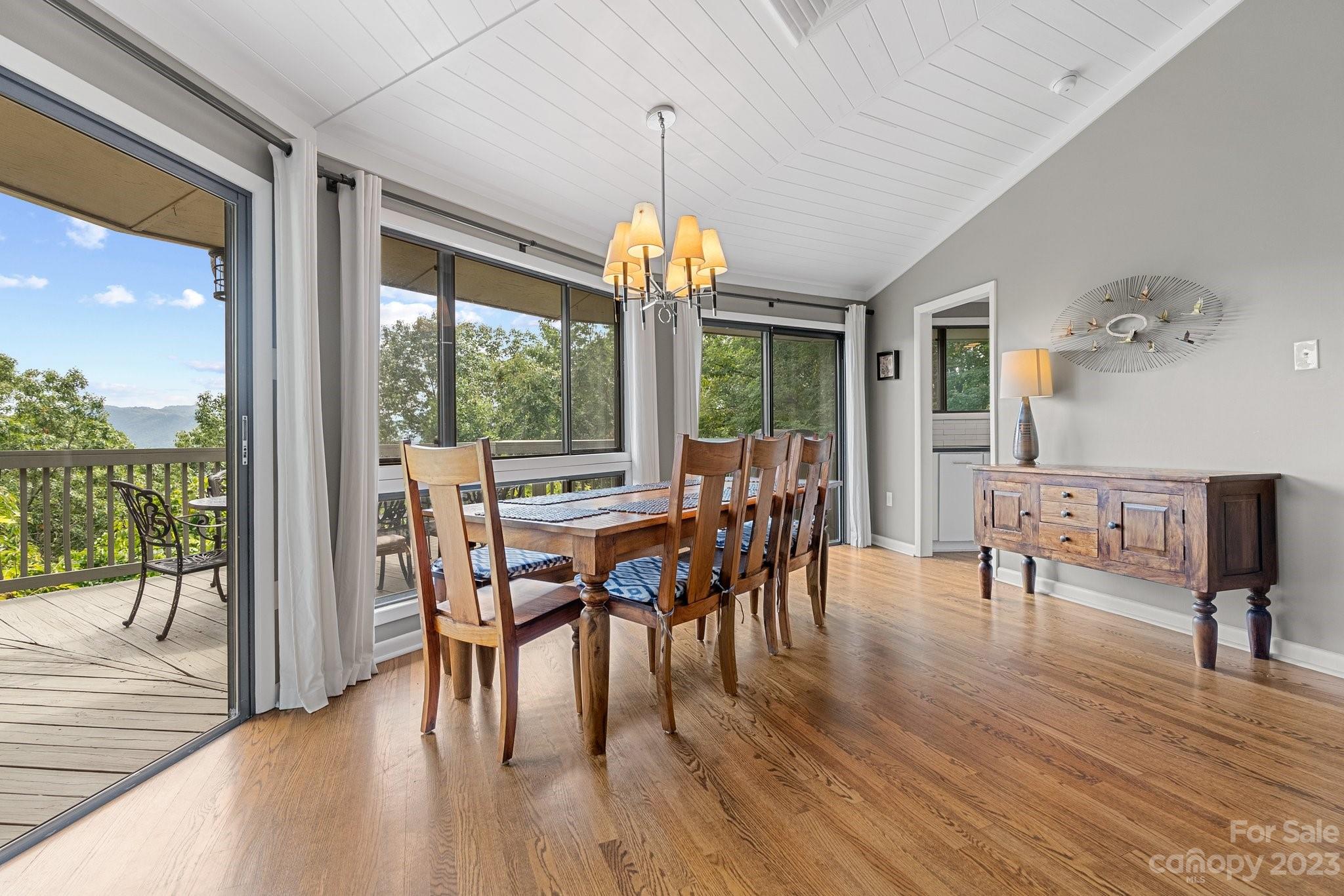 98 Westminster Road Montreat, NC 28711 - Photo 4 of 37 a dining room with furniture a chandelier and wooden floor