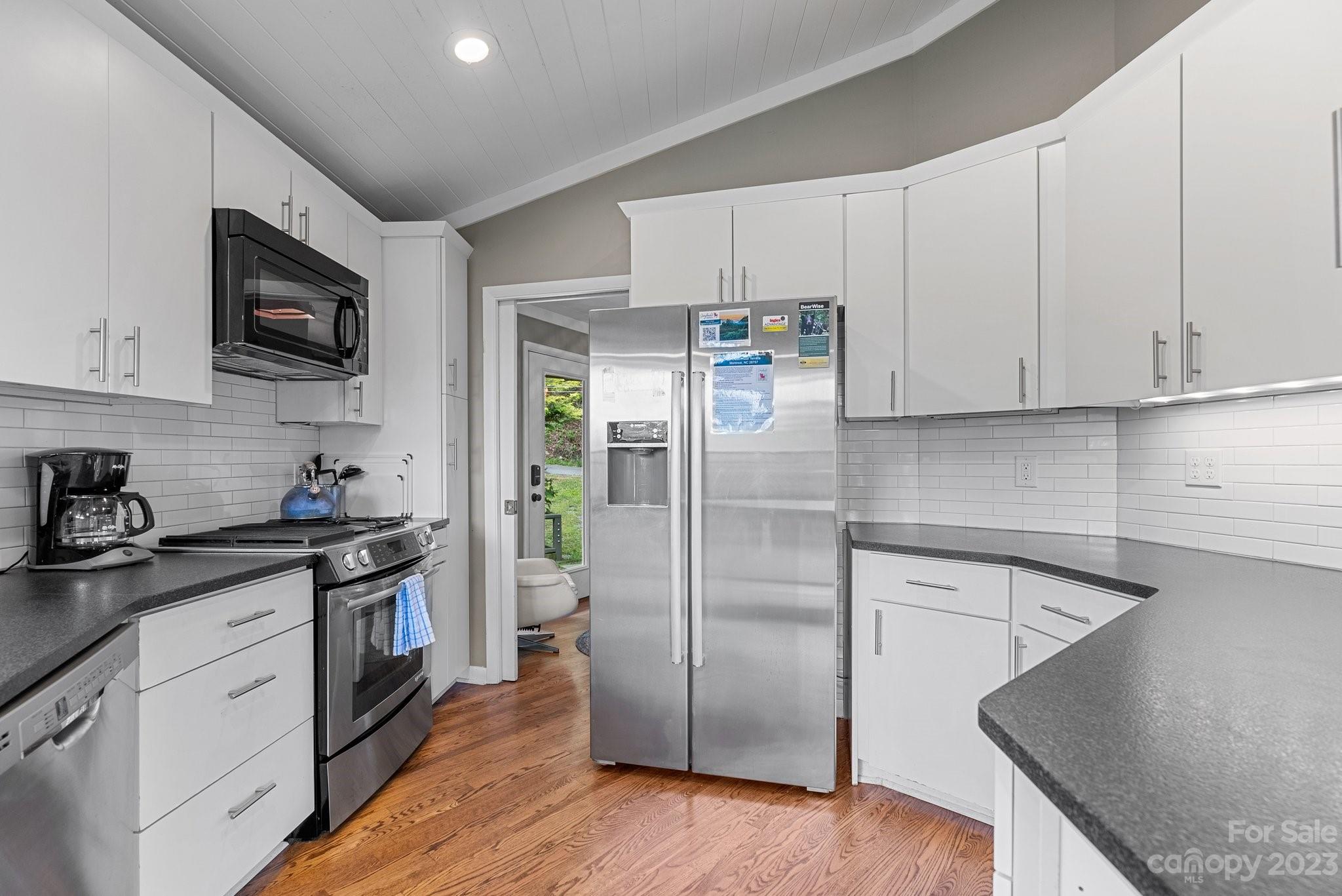 98 Westminster Road Montreat, NC 28711 - Photo 7 of 37 a kitchen with stainless steel appliances granite countertop a refrigerator sink and white cabinets