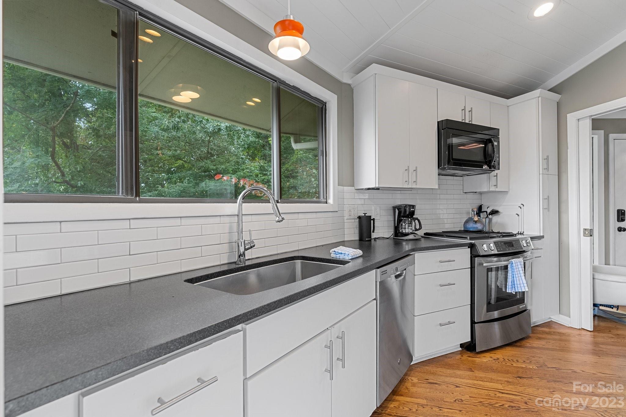 98 Westminster Road Montreat, NC 28711 - Photo 8 of 37 a kitchen with stainless steel appliances granite countertop a sink and a stove