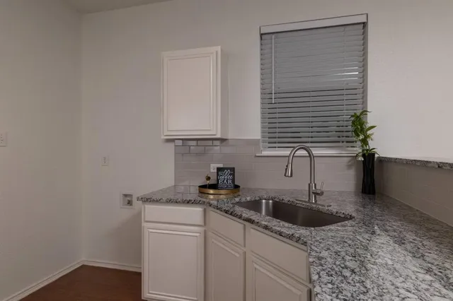 a kitchen with a sink and cabinets