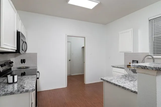 a kitchen with stainless steel appliances granite countertop a sink stove and cabinets