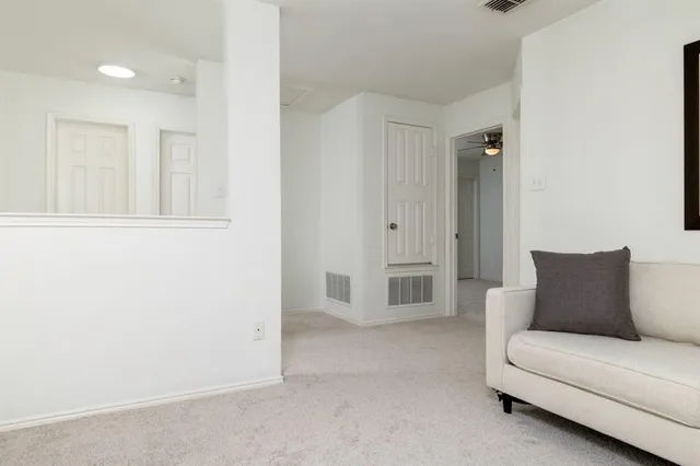 a living room with furniture and white walls