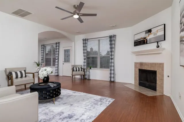 a living room with furniture and a fireplace