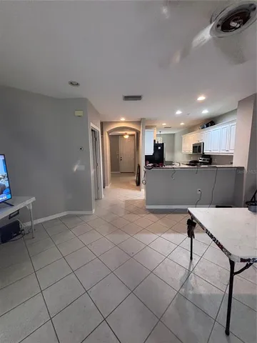 a white toilet sitting next to a white cabinet