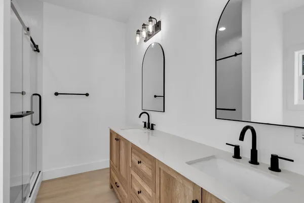 a kitchen with white cabinets and sink
