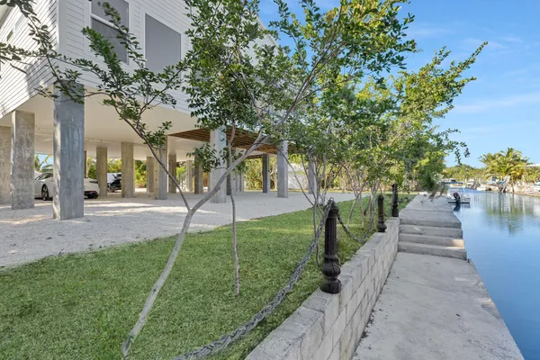 a kitchen with kitchen island white cabinets and refrigerator