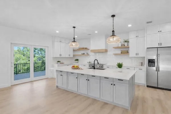 a view of a room with wooden floor