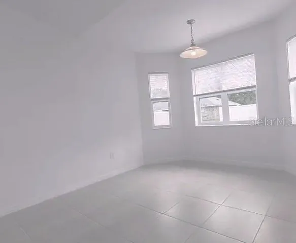 an empty room with windows and entrance