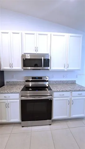 a stove top oven sitting inside of a kitchen