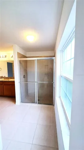 a view of hallway with a large window and a kitchen view