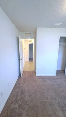 a view of a big room with closet and wooden door