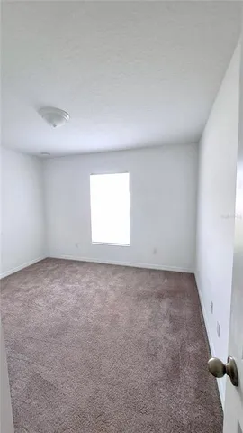 a view of an empty room and a window