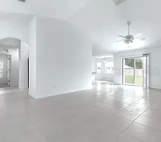a view of a livingroom with a ceiling fan and window