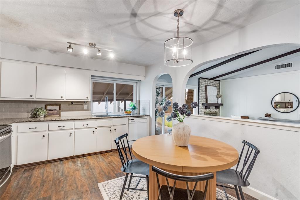 626 Shadyglen Drive Allen, TX 75002 - Photo 11 of 20 a kitchen with stainless steel appliances kitchen island granite countertop a dining table chairs and white cabinets