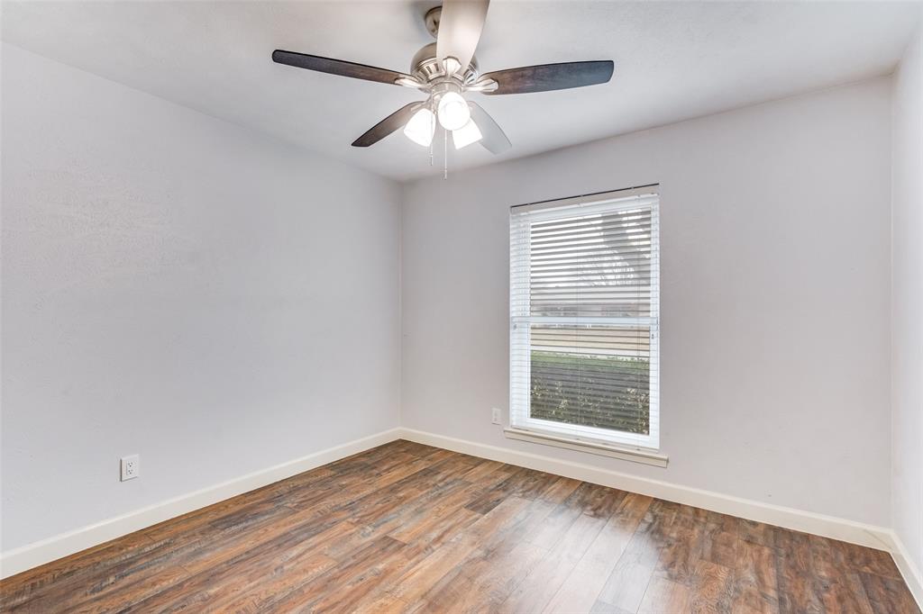 626 Shadyglen Drive Allen, TX 75002 - Photo 12 of 20 a view of an empty room with wooden floor and a window