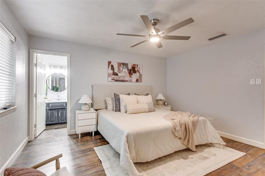 626 Shadyglen Drive Allen, TX 75002 - Photo 15 of 20 a bedroom with a large bed and a chandelier