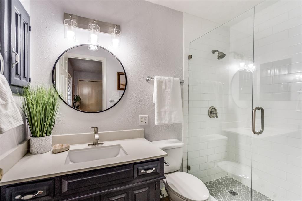 626 Shadyglen Drive Allen, TX 75002 - Photo 16 of 20 a bathroom with a granite countertop toilet sink and shower