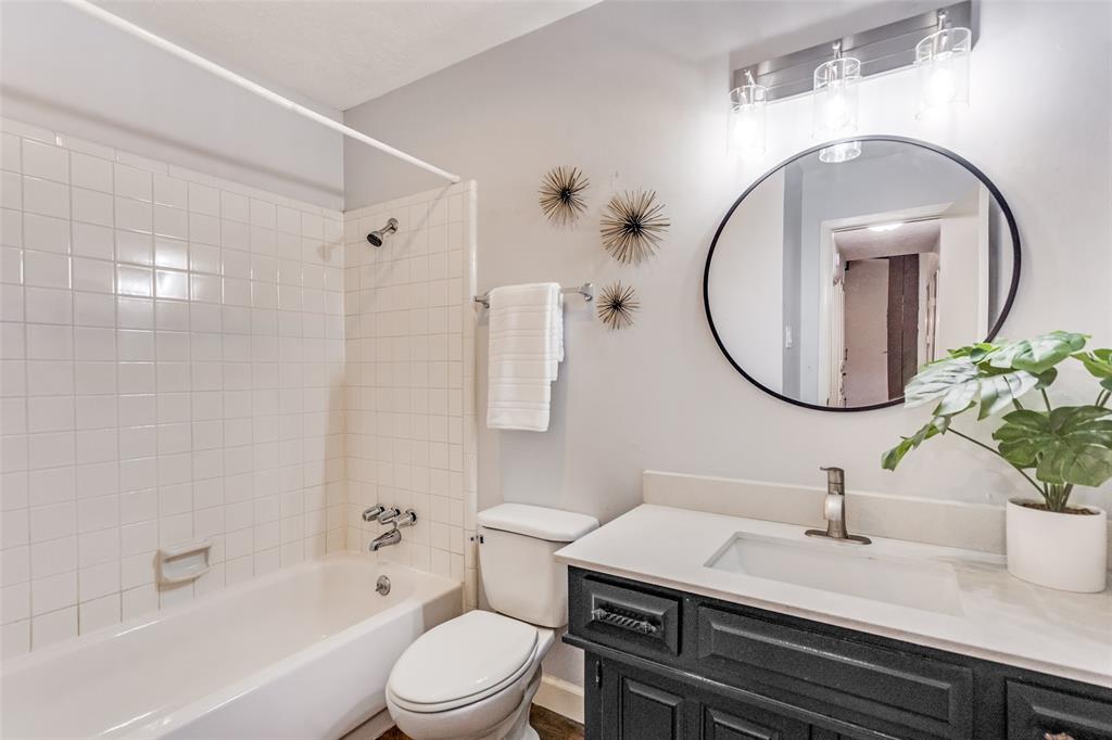 626 Shadyglen Drive Allen, TX 75002 - Photo 17 of 20 a bathroom with a sink a toilet and a mirror