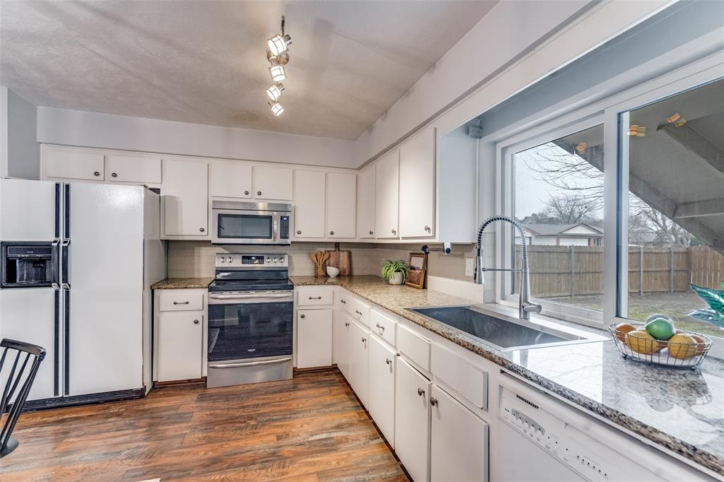 626 Shadyglen Drive Allen, TX 75002 - Photo 8 of 20 a kitchen with a sink a counter space cabinets and stainless steel appliances