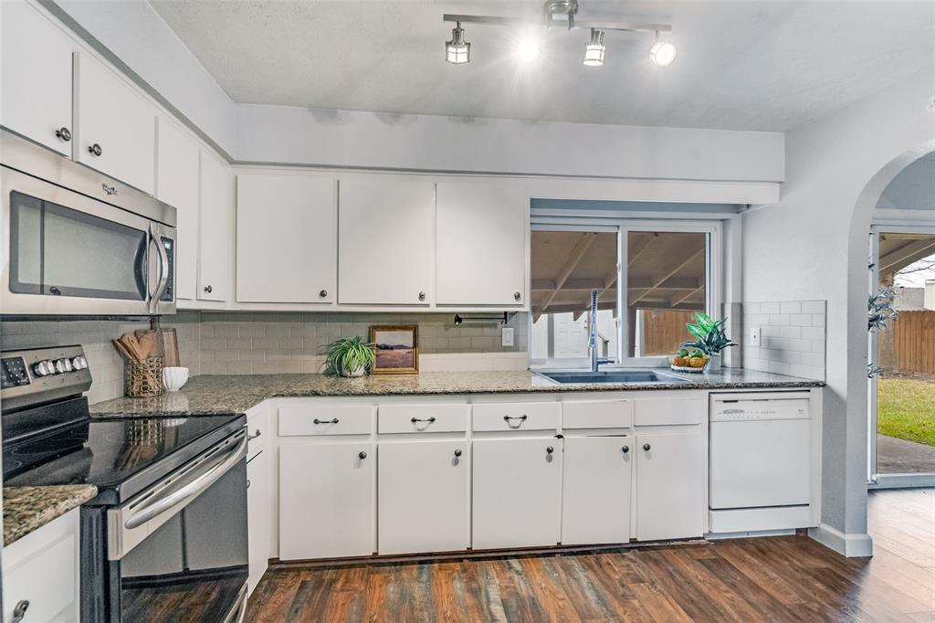 626 Shadyglen Drive Allen, TX 75002 - Photo 9 of 20 a kitchen with granite countertop white cabinets and stainless steel appliances