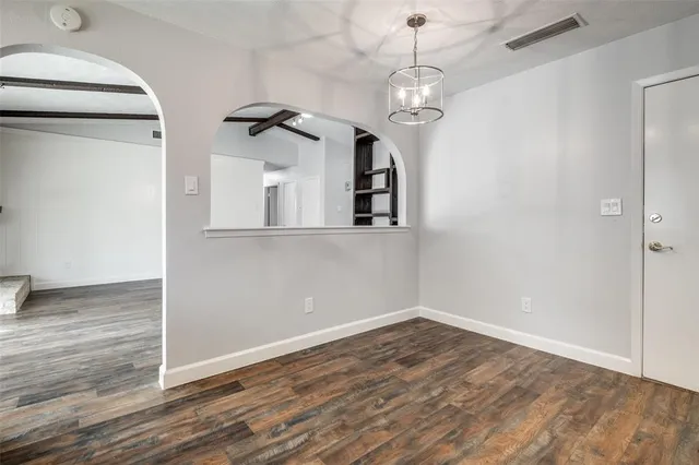 a view of a room with wooden floor and staircase